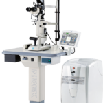 A Nidek Slit Lamp Biomicroscope With An Integrated Computer Screen And Control Panel On A Stand. The Unit Connects To A Larger, Wheeled Device Featuring Vents And A Cylindrical Component, Possibly For Additional Diagnostic Or Therapeutic Functions.