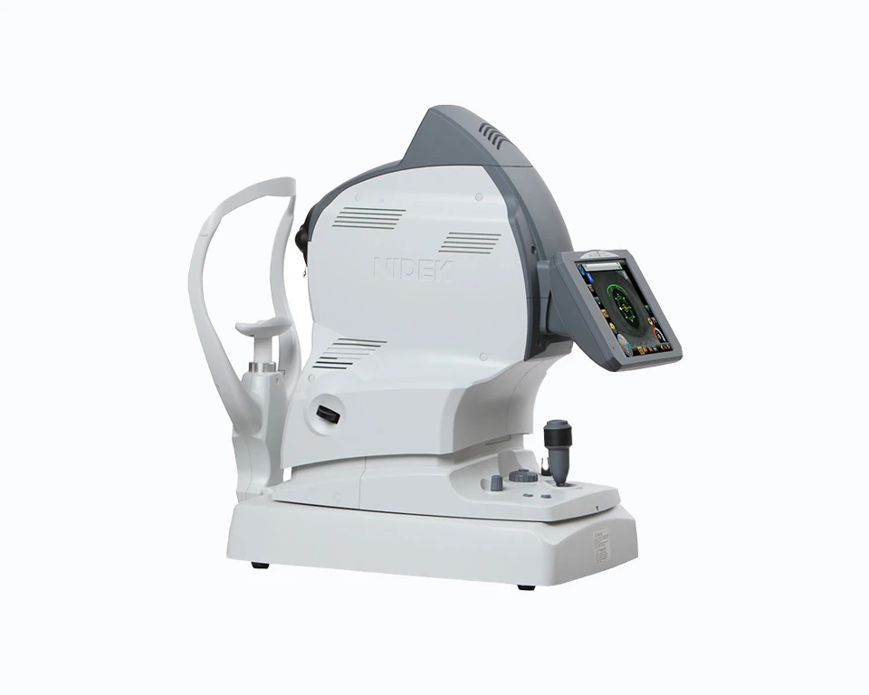 A Nidek Medical Imaging Device On A White Background, Featuring A Screen Displaying An Eye Scan. The Device Is Predominantly White With Gray Accents, Boasting A Sleek Design And Various Components For Eye Examination, Including A Chin Rest And Joystick Control.