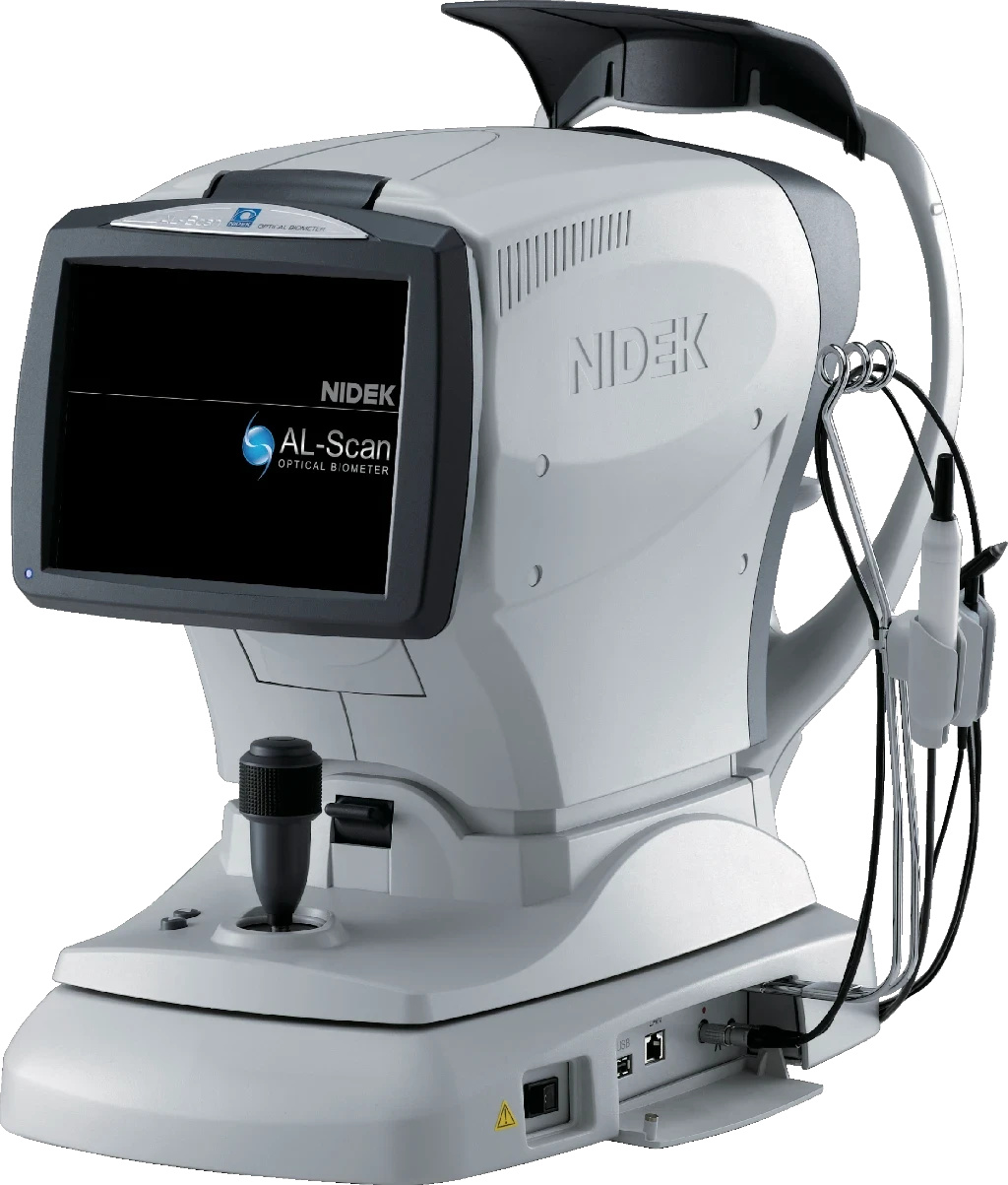 A Close-Up Of A Nidek Al-Scan Optical Biometer. The Device Is Gray And Features A Monitor Displaying The Nidek Logo And Model Name. Various Cables And Connectors Are Attached, And There Is A Joystick For Control On The Base.