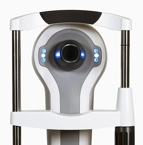 A Close-Up View Of A Modern White And Gray Nidek Medical Device With A Circular Lens At The Center, Surrounded By Blue Indicator Lights. The Device Is Supported By Vertical Rods On Either Side And Appears To Be Used For Eye Examinations Or Measurements.