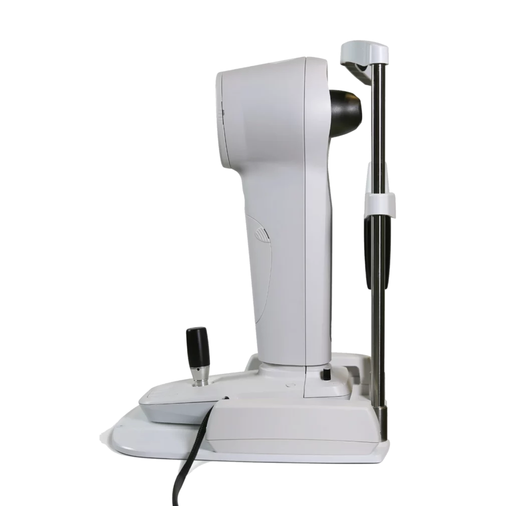 A Side View Of A White Nidek Ophthalmic Device, Likely A Slit Lamp Or Similar Diagnostic Equipment Used For Examining Eyes. The Device Is Mounted On A Base, With An Adjustable Headrest And Chin Rest Attached To Support A Patient'S Head.