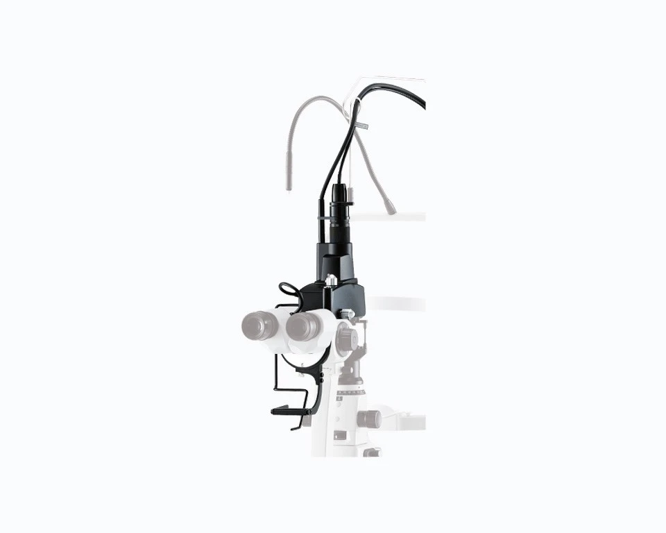 Close-Up View Of A Sleek Black And White Nidek Dental Microscope With Multiple Lenses And Ergonomic Handles, Designed For Precision Work In Dentistry. Various Cords And Attachments Are Connected To The Device, Which Is Mounted On A Stand.