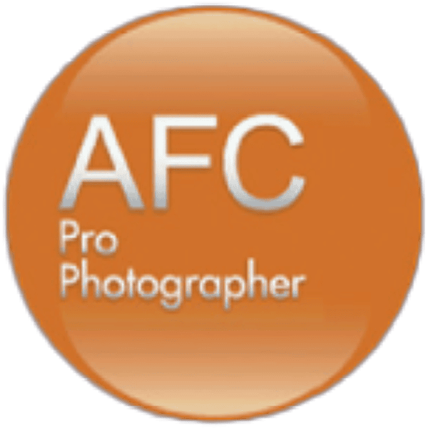 A Round Orange Logo With White Text In The Center. The Text Reads &Quot;Afc Pro Photographer&Quot; With A Subtle Nod To Nidek.